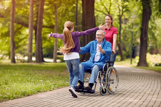 Man in Wheel Chair and Caregiver 