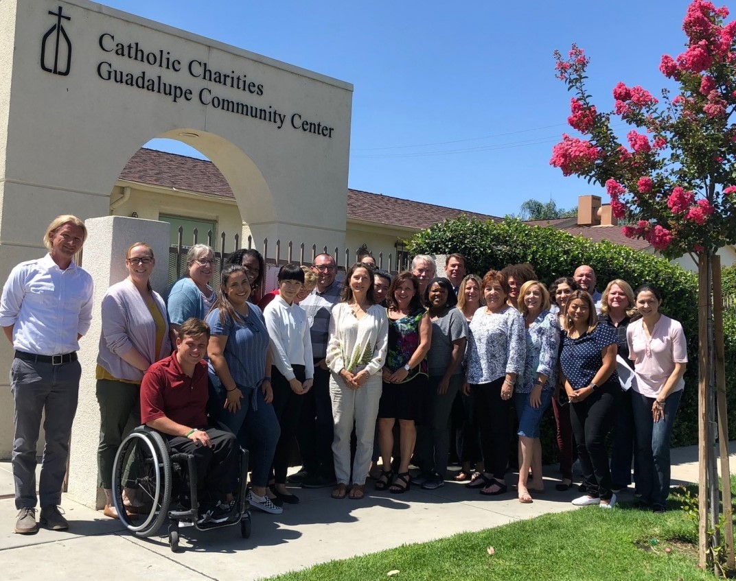 participants of disaster case manager training in front of catholic charities guadalupe community center building